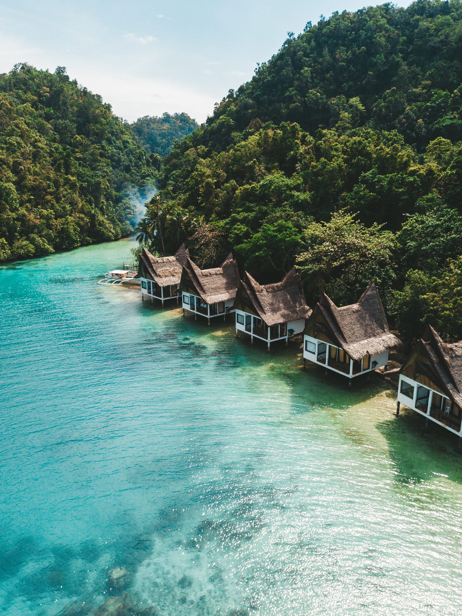 set of cottages on the ocean under the blue sky