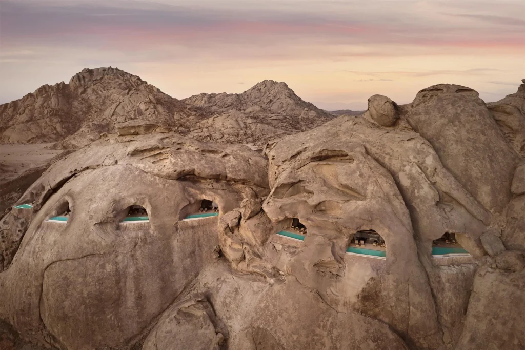 Desert Rock Resort Wadi Rum — sandstone cliff room interior with natural light