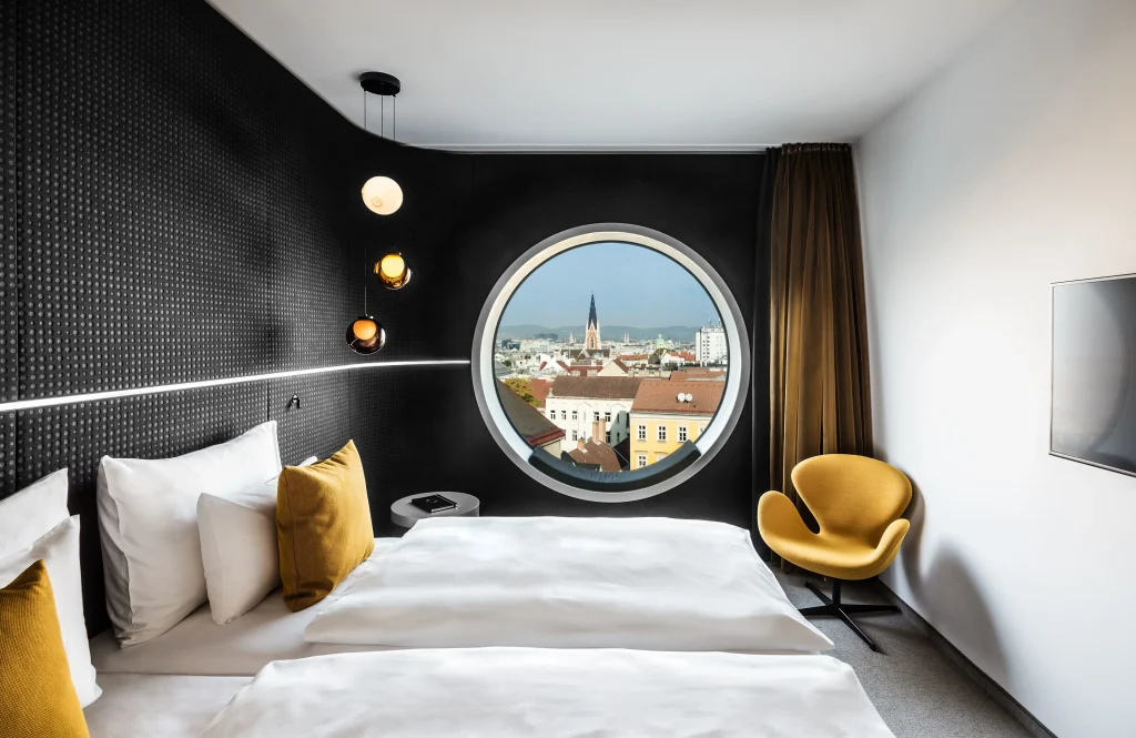 MOOONS Vienna Upper Space room with round skylight window and city views