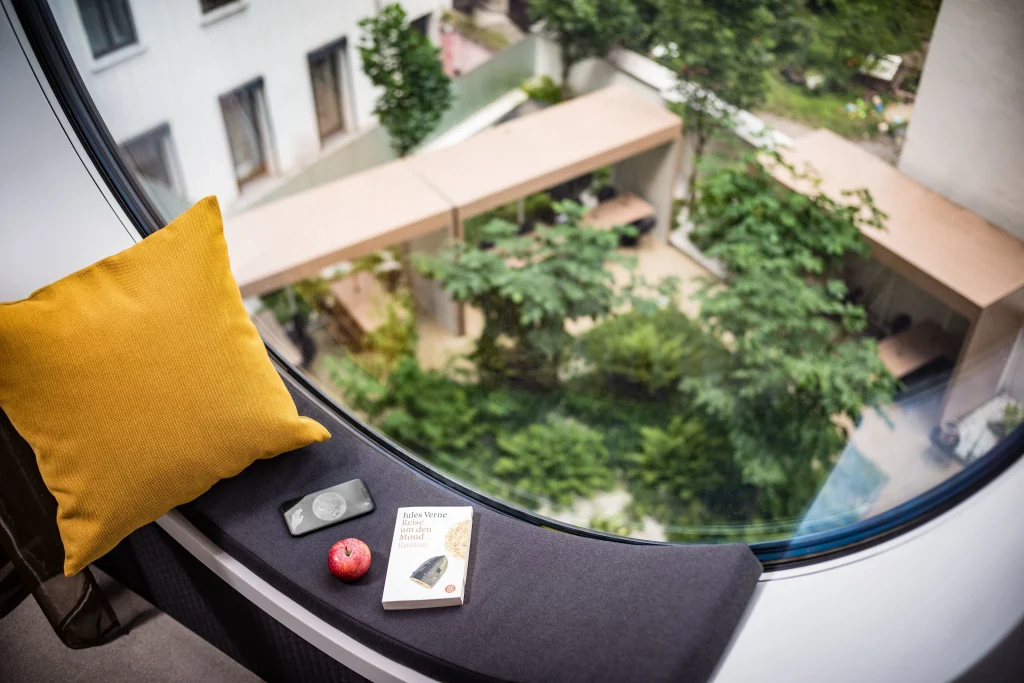 MOOONS Vienna circular panoramic window with view over Quartier Belvedere