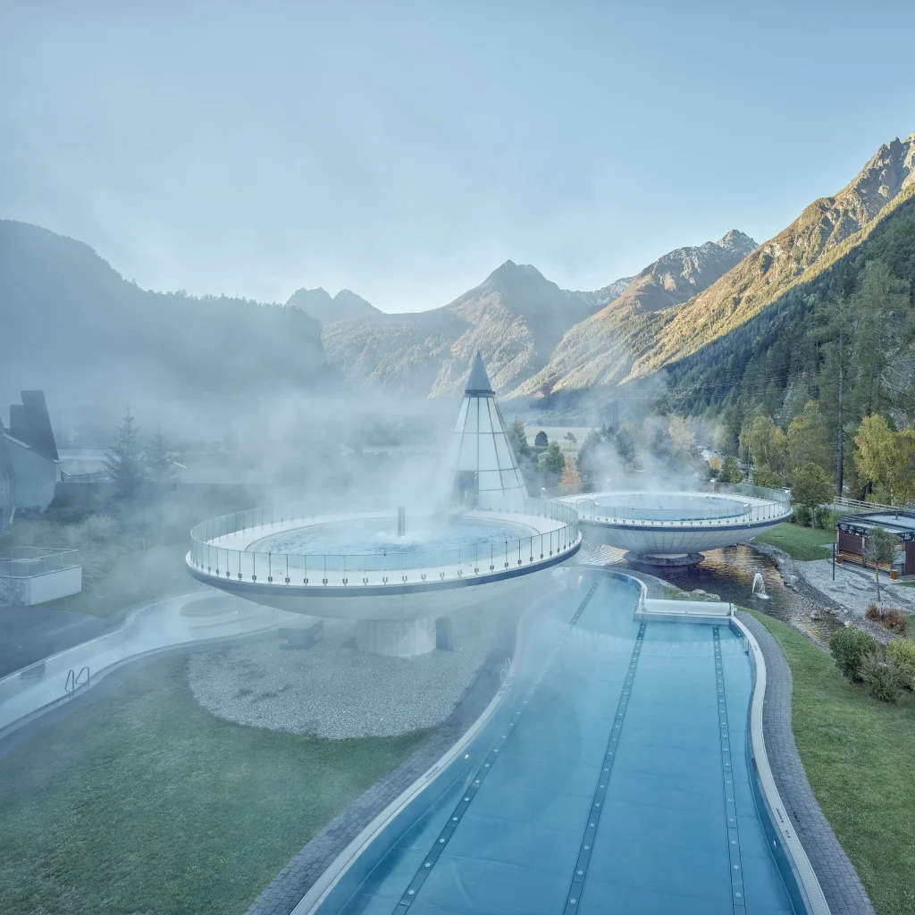 Aqua Dome outdoor bathing terraces with snow-covered peaks in the background