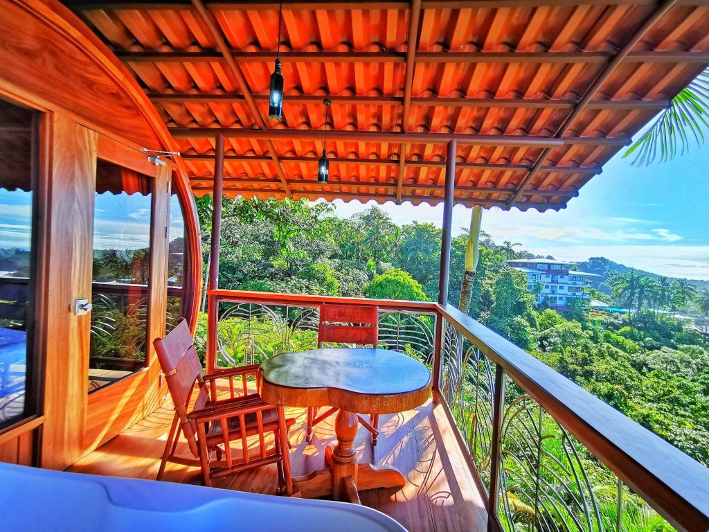 View from the cockpit window of Hotel Costa Verde's 727 suite — rainforest canopy and Pacific Ocean, Quepos Costa Rica