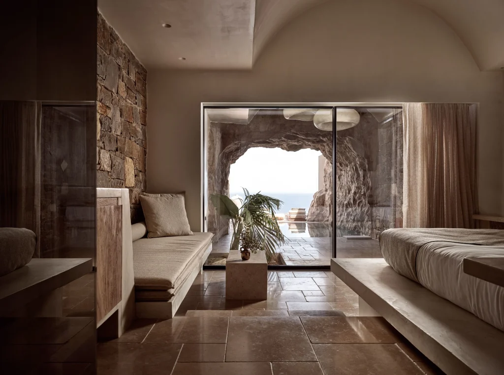 Acro Suites Cave Suite interior carved into the cliff face with private plunge pool and sea view