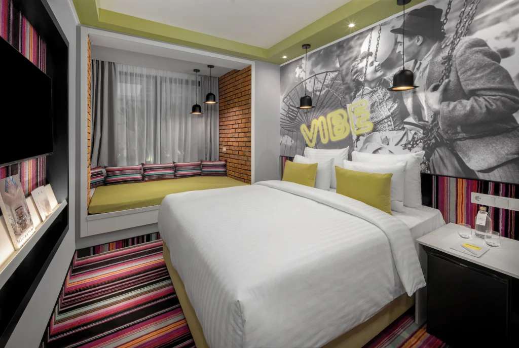 Retro-designed bedroom with warm groovy tones at Mamaison VIBE Hotel Budapest