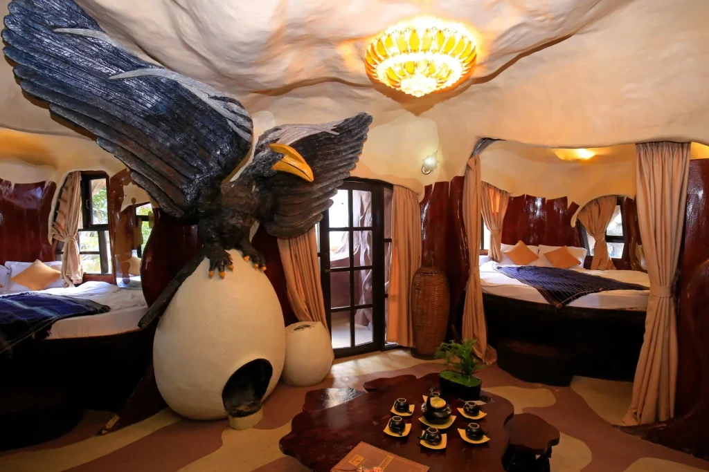 Eagle Room at Crazy House Da Lat — eagle-shaped fireplace and organic carved walls in a uniquely themed guesthouse room