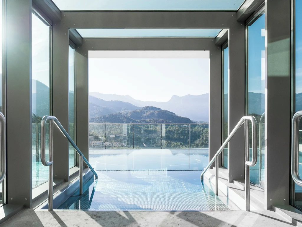 Infinity pool at Jumeirah Port Soller Hotel built on a cliff ledge with panoramic views of the Mediterranean Sea