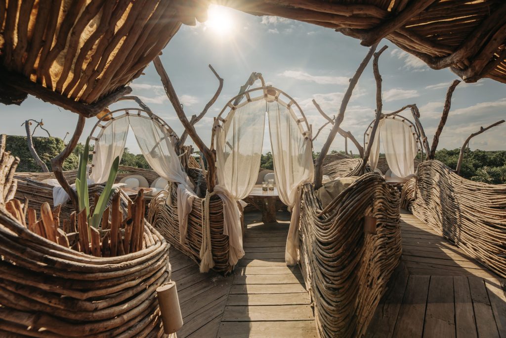 Kin Toh restaurant at Azulik Tulum — suspended nest-like dining structures 12 meters above the jungle canopy with open-air views at sunset