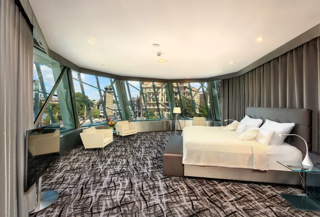 Dancing House Hotel Prague suite interior — curved floor-to-ceiling windows with Vltava River views from inside the glass Ginger tower