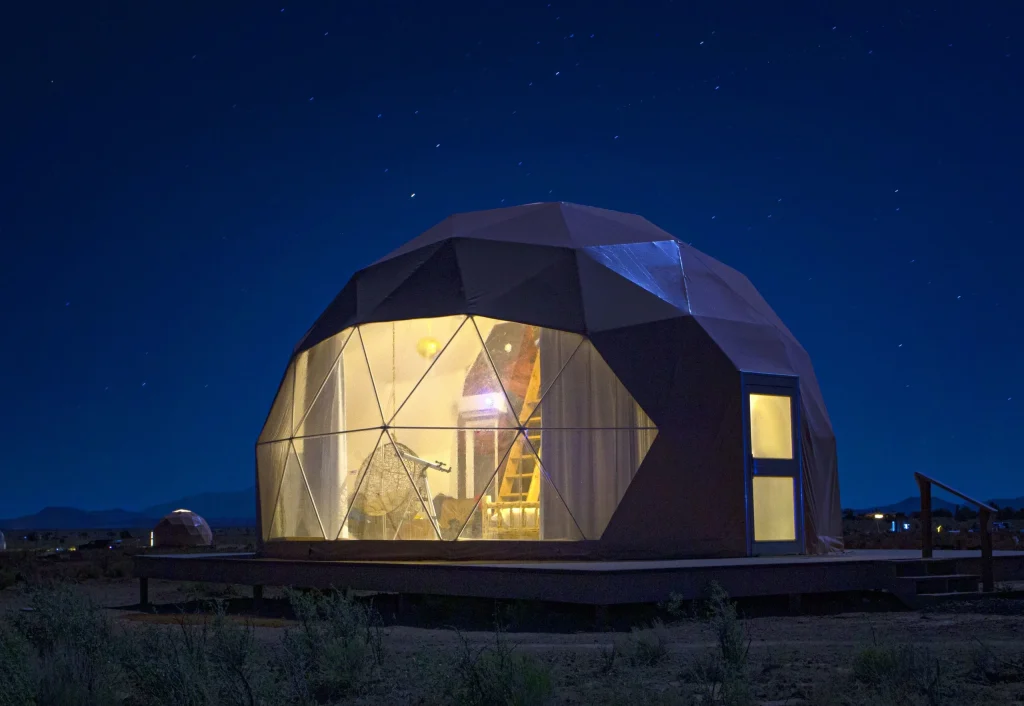 Glass sky dome cabin at Clear Sky Resorts Grand Canyon with panoramic views of the canyon landscape at dusk