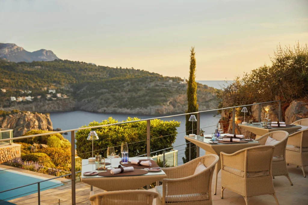 Private terrace of a room at Jumeirah Port Soller Hotel overlooking the Mediterranean bay with Moorish-inspired arch detail