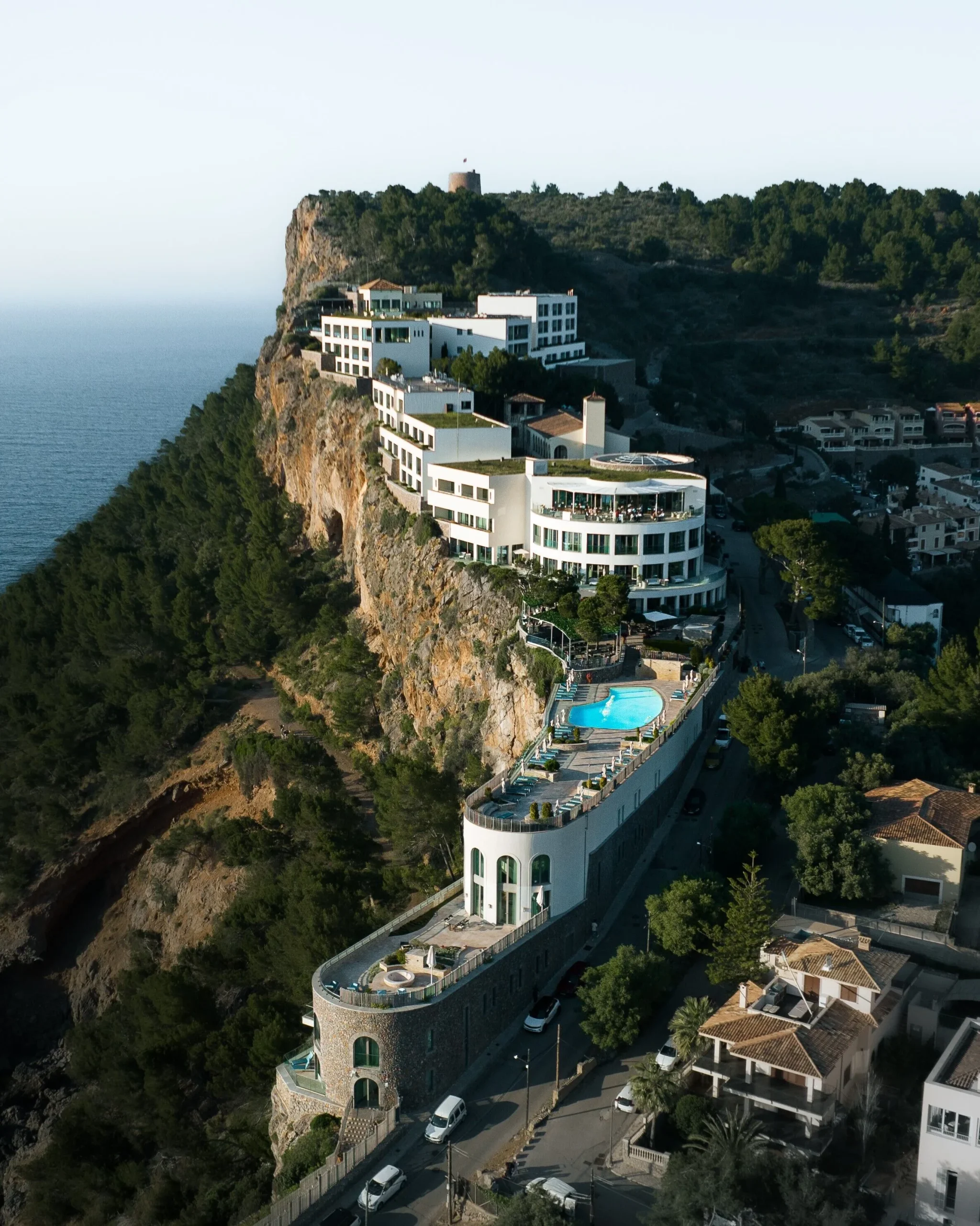 Aerial view of Jumeirah Port Soller Hotel terraced into the cliff above Port de Sóller bay, Mallorca