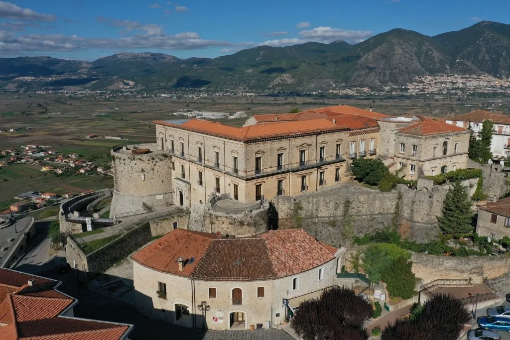 Exterior of Macchiaroli Castle in Teggiano, medieval Norman towers against the Campania hillside