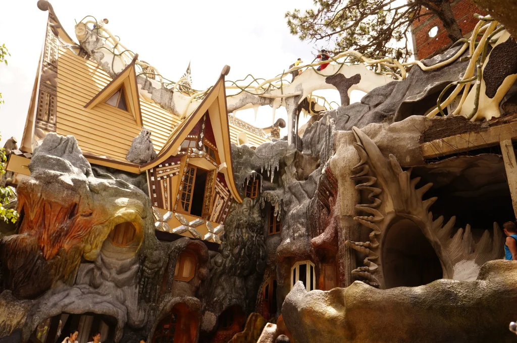 Crazy House Da Lat exterior — a five-story organic structure resembling a giant banyan tree, with branch-like forms rising above the roofline
