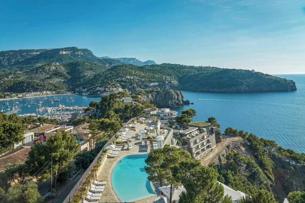Stone-clad terraced facade of Jumeirah Port Soller Hotel with stepped levels following the cliff gradient