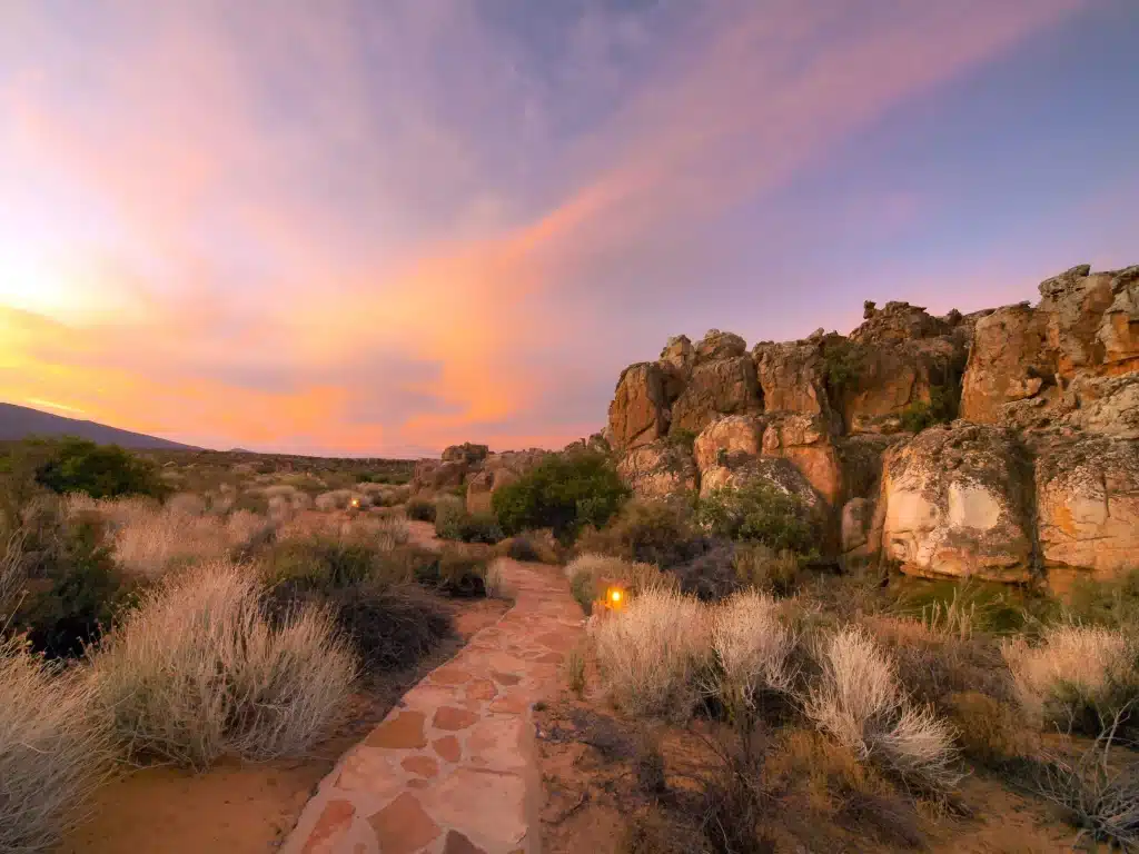 Kagga Kamma Eco Lodge surrounded by sandstone formations at golden hour