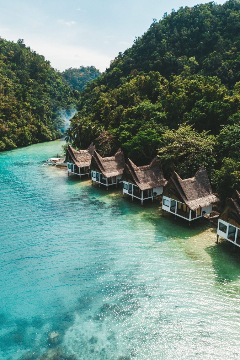set of cottages on the ocean under the blue sky